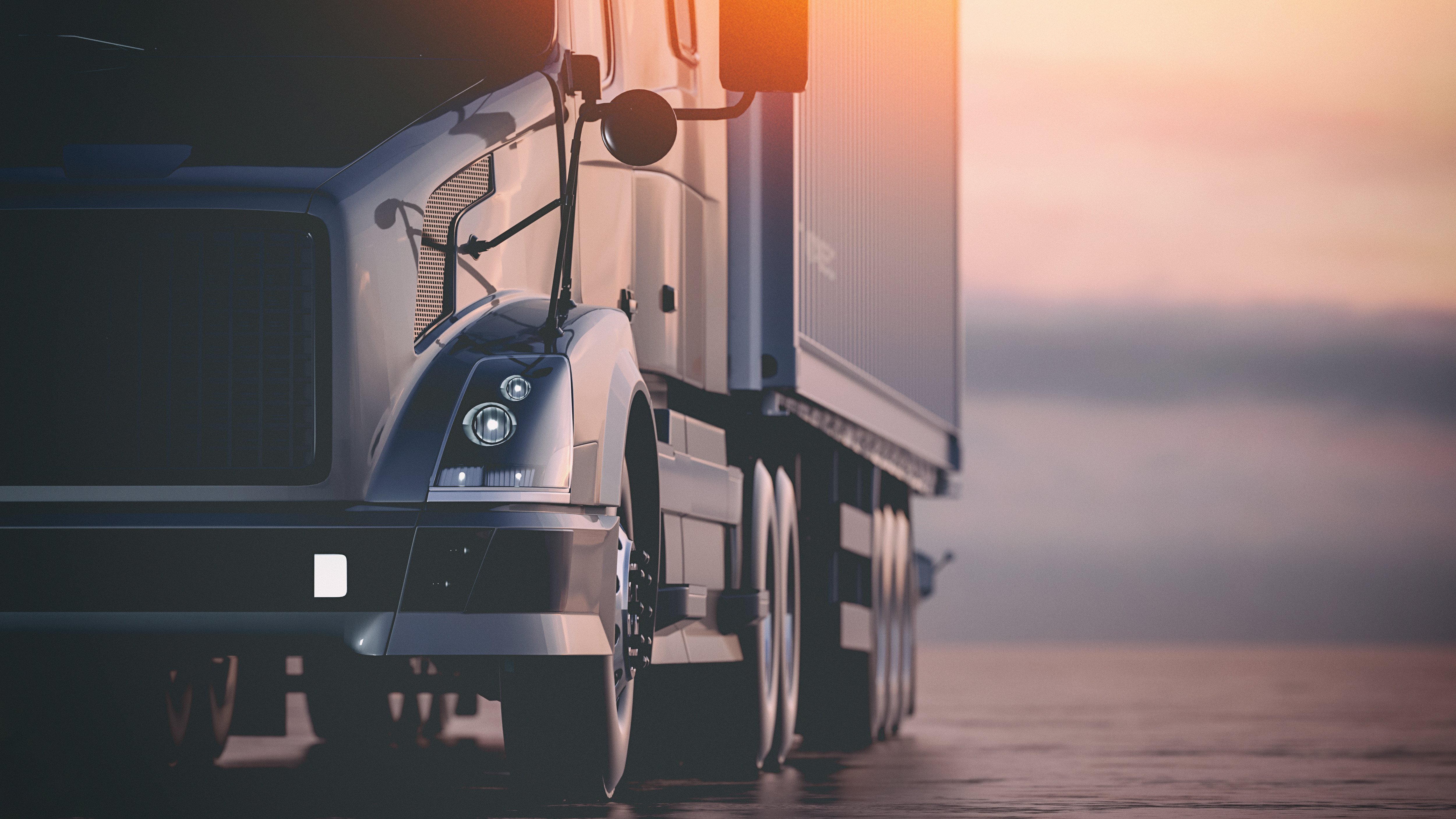 A close-up of a modern semi-truck at sunset, symbolizing efficient and optimized logistics and PTL transportation practices.