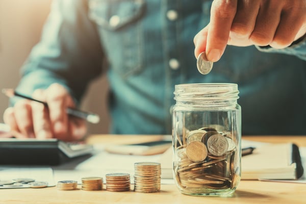 Person counting money while budgeting